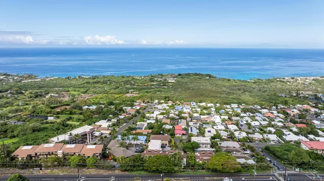 an aerial view of residential building and ocean