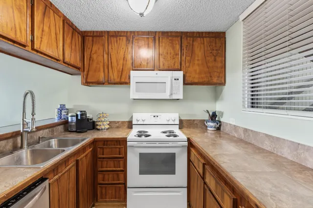 a utility room with cabinets washer and dryer