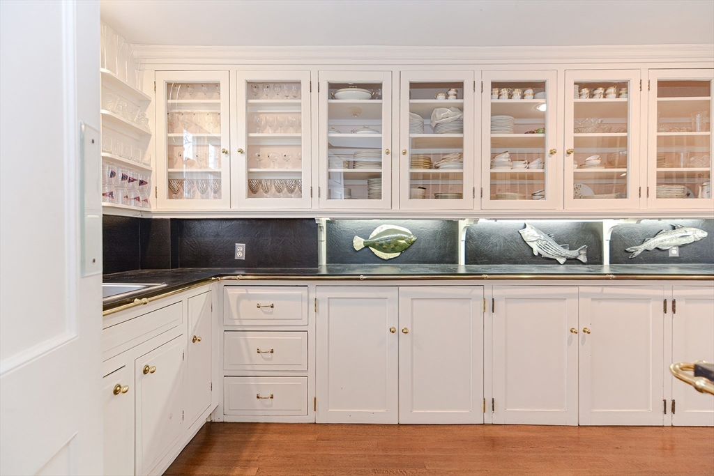 33 Way Road Gloucester, MA 01930 - Photo 17 of 38 a kitchen with stainless steel appliances cabinets and a flat screen tv