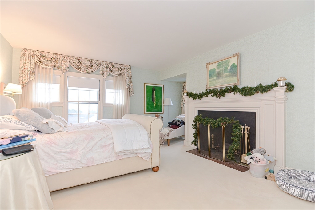 33 Way Road Gloucester, MA 01930 - Photo 27 of 38 a bedroom with a bed and a fireplace