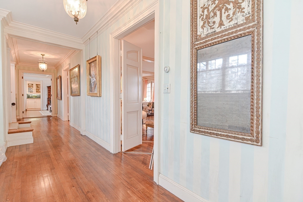 33 Way Road Gloucester, MA 01930 - Photo 7 of 38 a view of a hallway with wooden floor and a large mirror