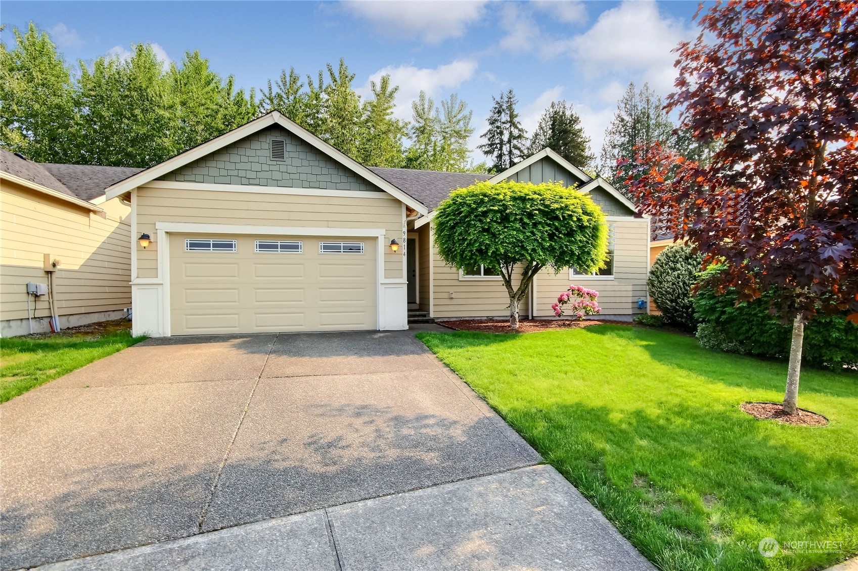 a front view of a house with a yard and garage