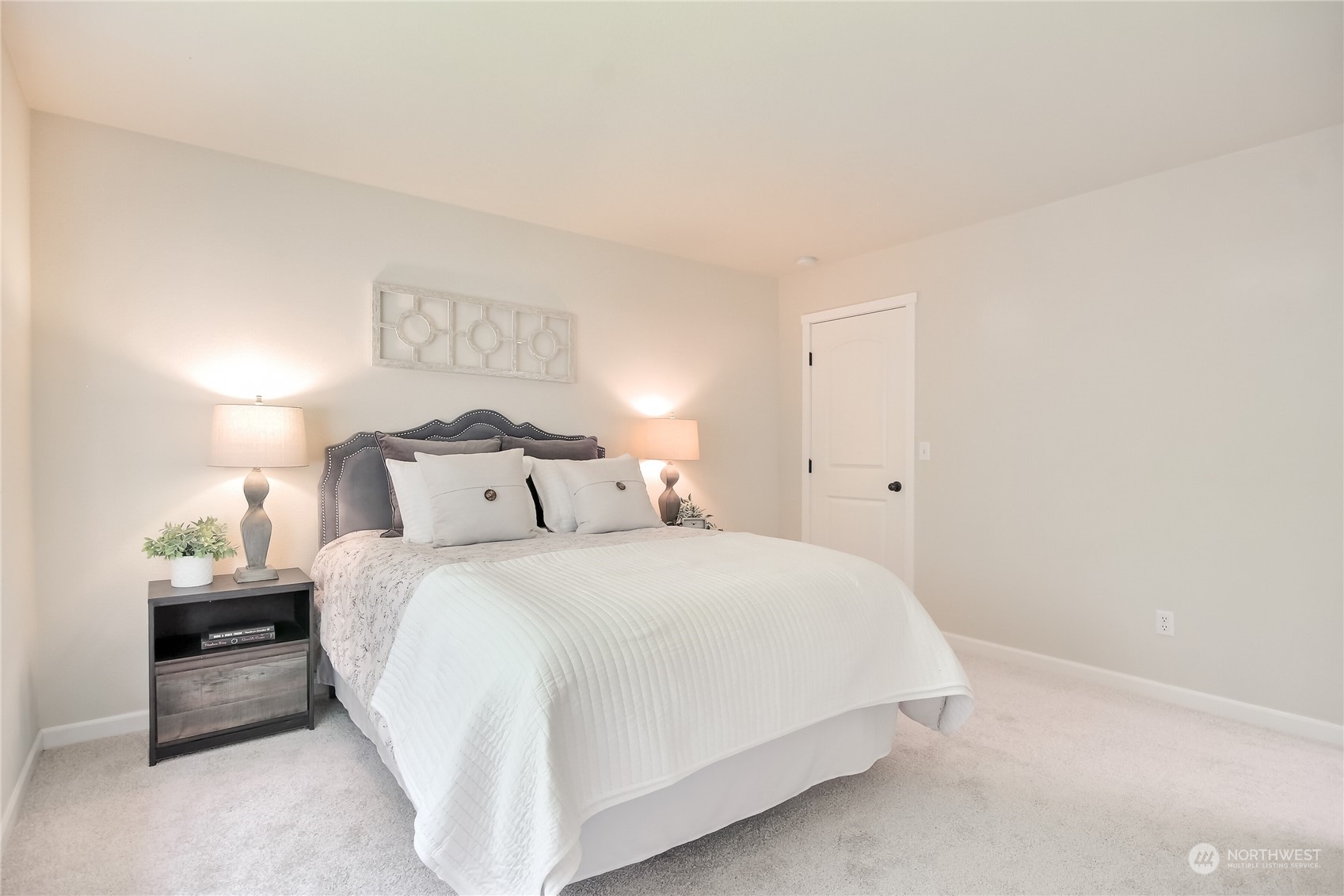 9814 201st Street East Graham, WA 98338 - Photo 16 of 40 a bedroom with a bed and a lamp