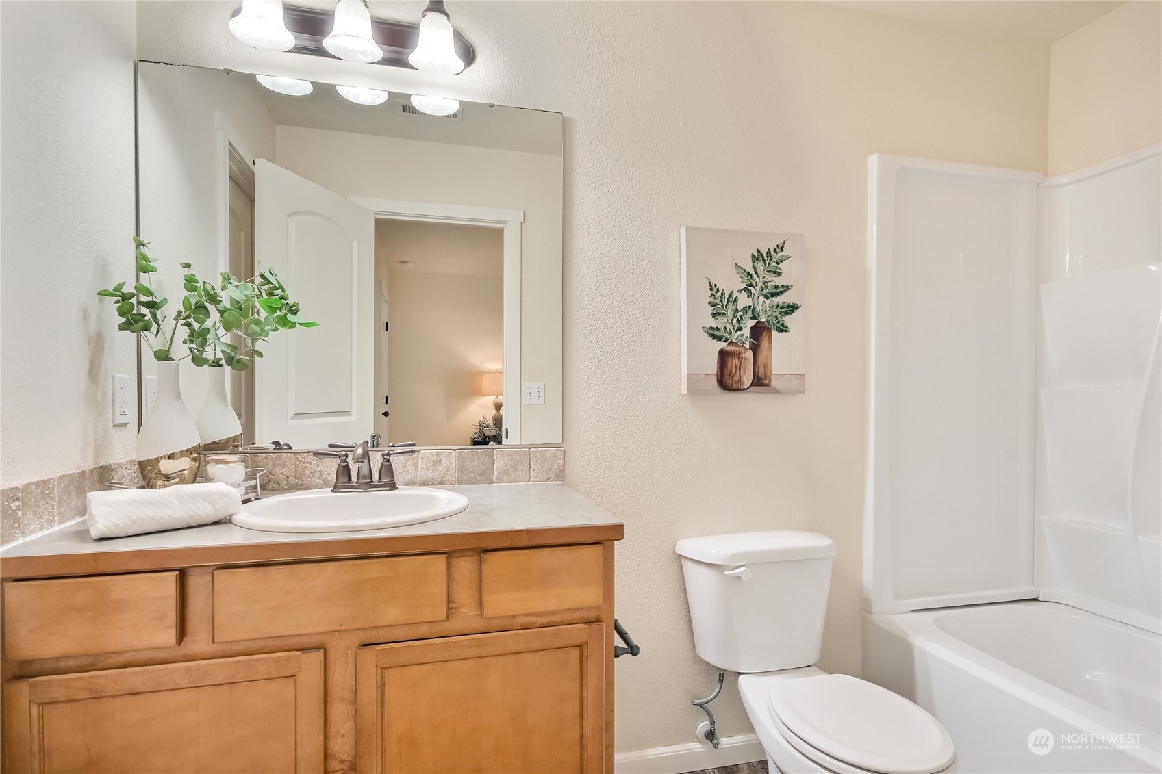 9814 201st Street East Graham, WA 98338 - Photo 18 of 40 a bathroom with a toilet sink and mirror