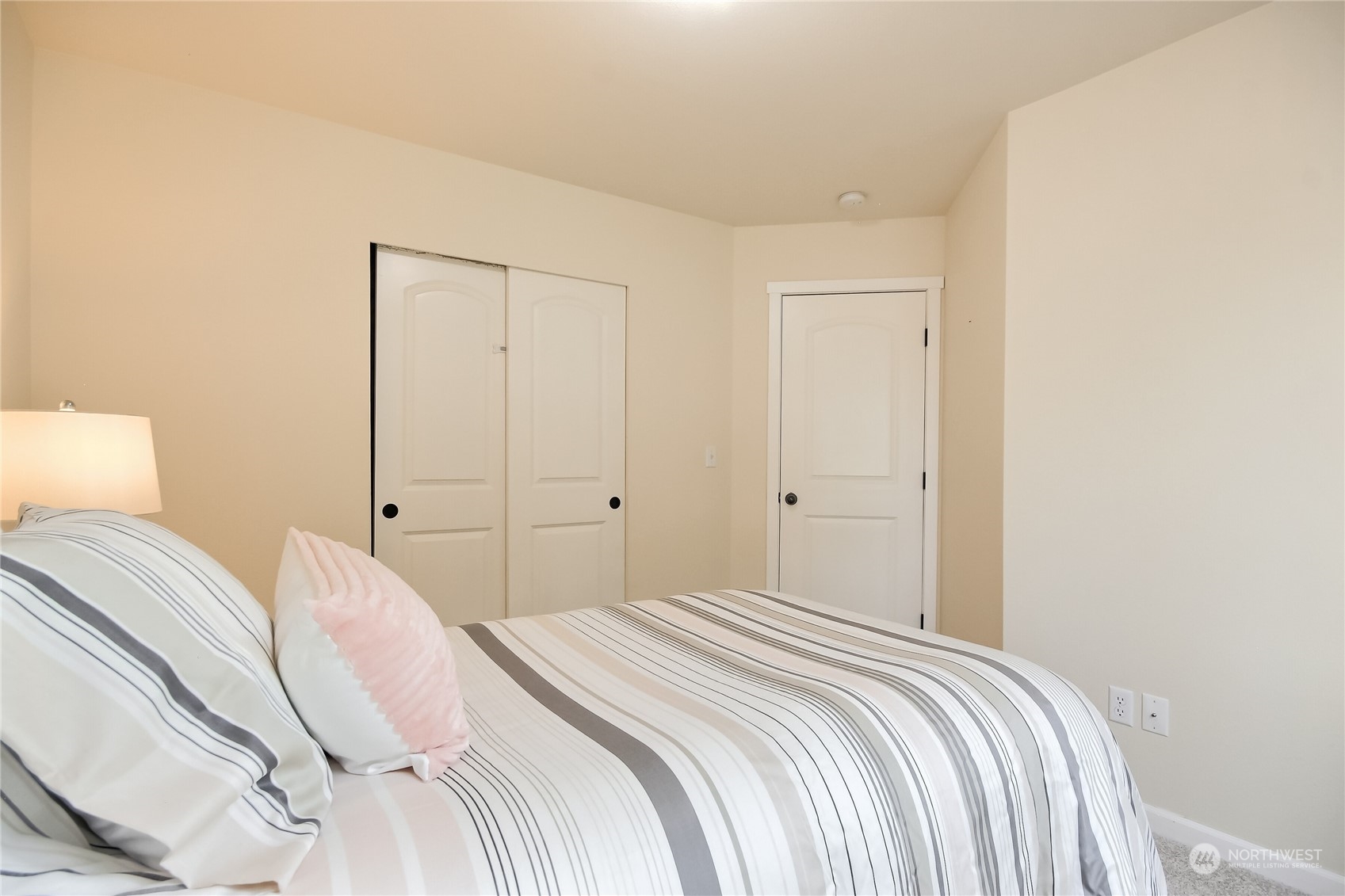 9814 201st Street East Graham, WA 98338 - Photo 24 of 40 a bedroom with a bed and a night lamp