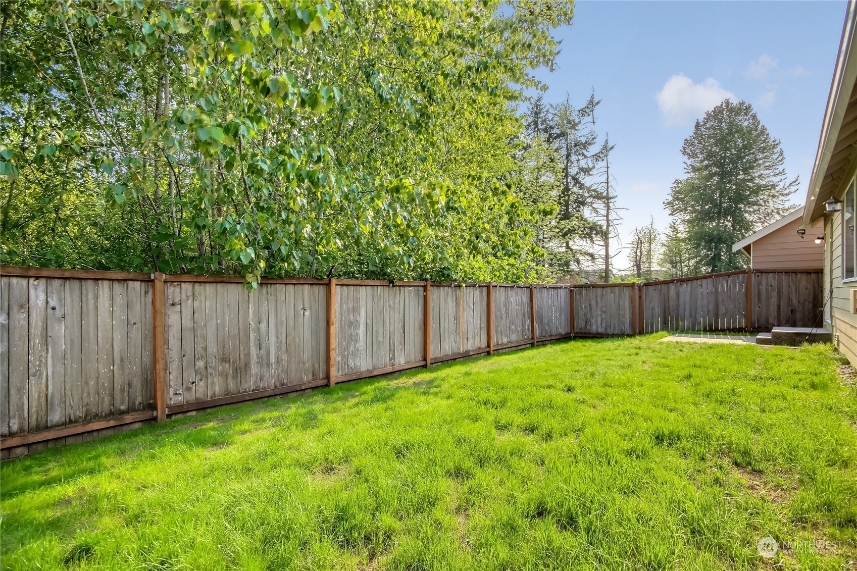 9814 201st Street East Graham, WA 98338 - Photo 28 of 40 a view of a yard with wooden fence
