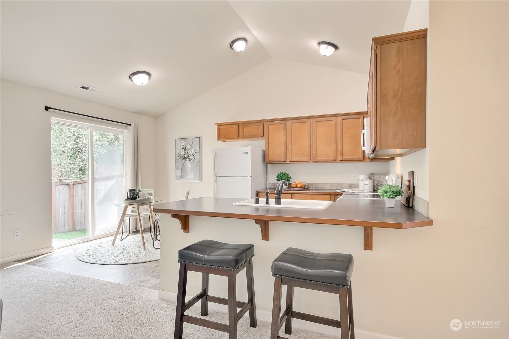 9814 201st Street East Graham, WA 98338 - Photo 6 of 40 a kitchen with a sink cabinets and window