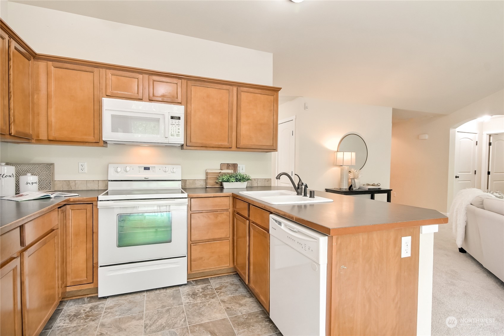 9814 201st Street East Graham, WA 98338 - Photo 8 of 40 a kitchen with stainless steel appliances granite countertop a sink stove and cabinets