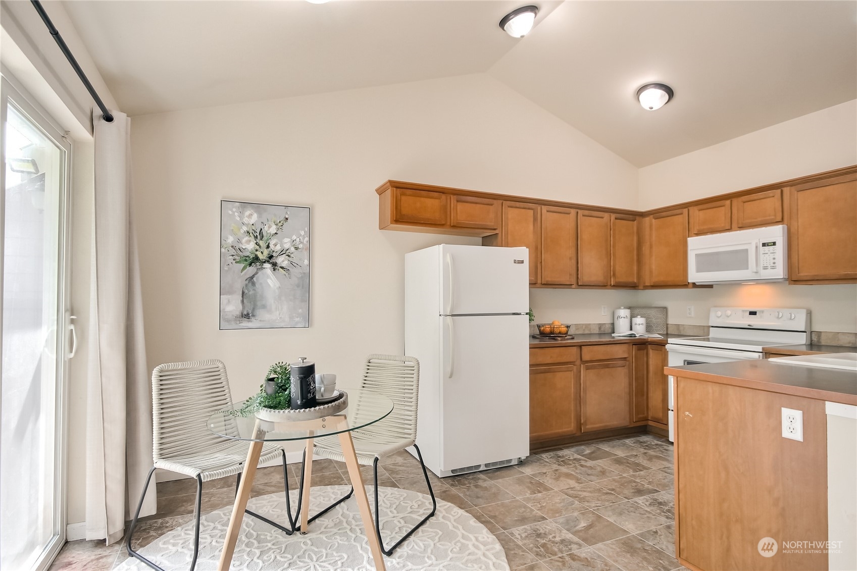 9814 201st Street East Graham, WA 98338 - Photo 10 of 40 a kitchen with stainless steel appliances granite countertop a refrigerator and a stove top oven