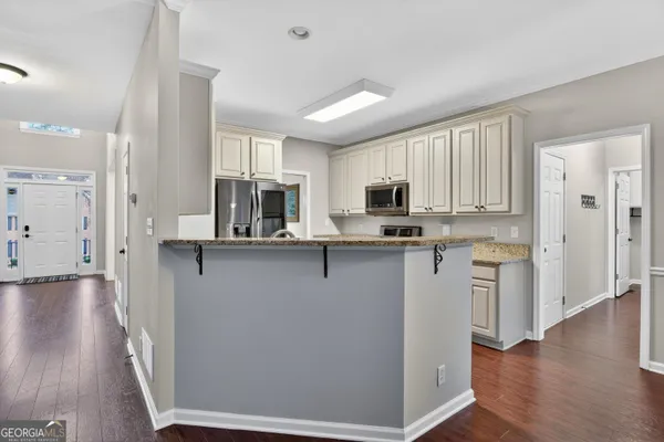 a kitchen with stainless steel appliances a refrigerator sink and microwave