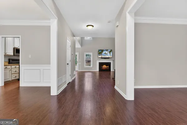 a view of empty room with wooden floor