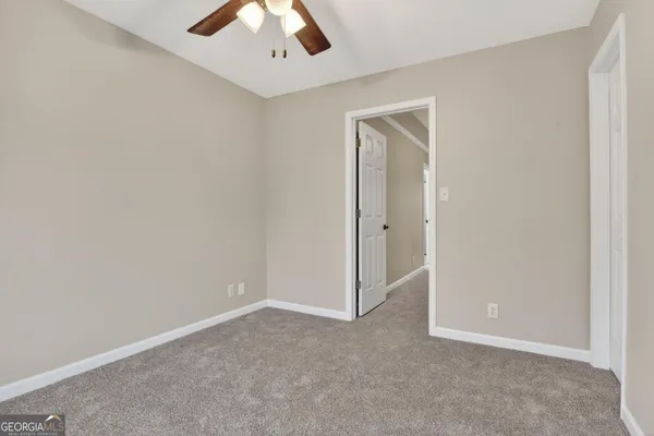 an empty room with a ceiling fan