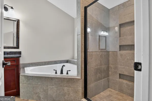 a bathroom with a bathtub and shower
