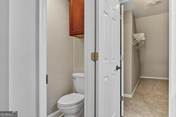 a bathroom with a granite countertop toilet and a shower