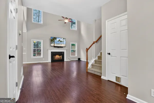 a view of a livingroom with wooden floor and furniture