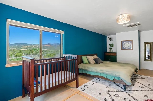 a bedroom with a bed a table and chair