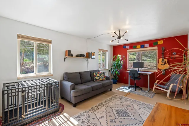 a living room with furniture a rug and a flat screen tv