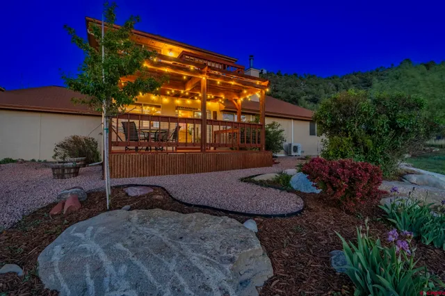 a view of backyard with outdoor seating and green space