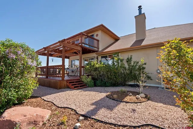 a front view of a house with a yard and green space