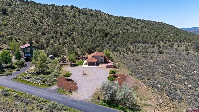 an aerial view of a house with a yard