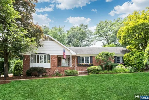 a view of a house with a yard and potted plants