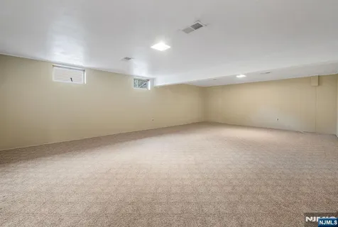 an empty room with a empty space and windows