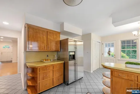 a kitchen with stainless steel appliances kitchen island granite countertop a sink and cabinets