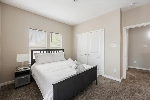 a bedroom with a bed and a night stand
