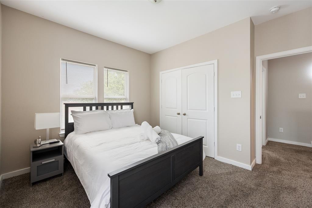 5004 Colonial Avenue Dallas, TX 75215 - Photo 11 of 20 a bedroom with a bed and a night stand