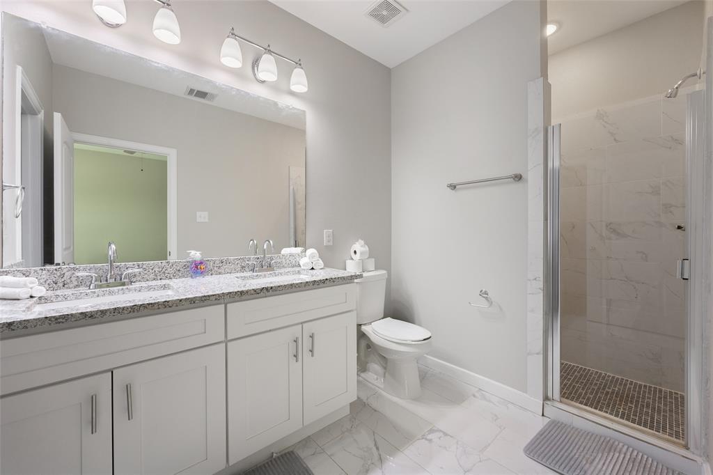 5004 Colonial Avenue Dallas, TX 75215 - Photo 17 of 20 a bathroom with a granite countertop sink toilet and shower