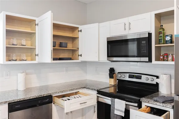 a kitchen with cabinets and appliances