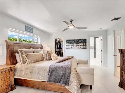 a bedroom with a bed couch and a window