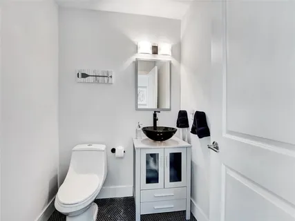 a white toilet sitting next to a bathroom sink