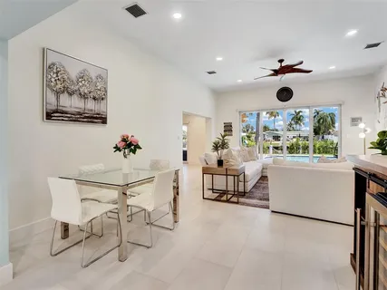 a dining room with furniture and window