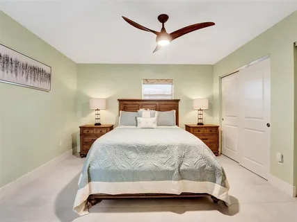 a bedroom with a bed and painting on the wall