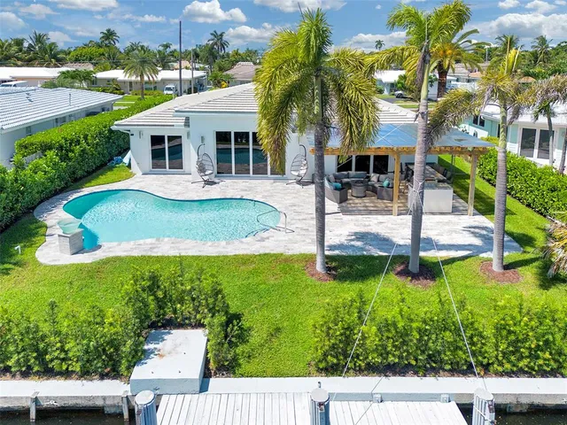 a view of a house with pool and a yard