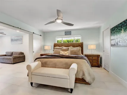 a bedroom with a bed and ceiling fan