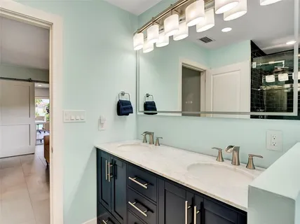 a bathroom with a sink a vanity and a mirror