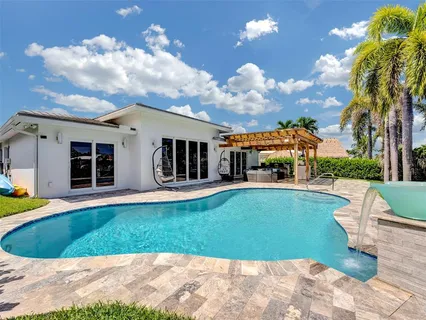 a view of a house with a swimming pool and a yard