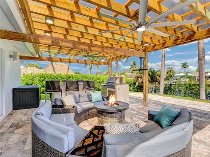 a living room with patio furniture and a potted plant