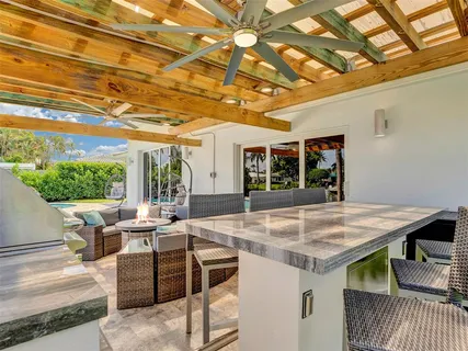 a view of a patio with table and chairs