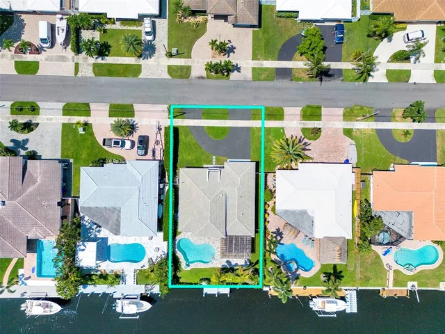 an aerial view of a building with yard garage and outdoor seating