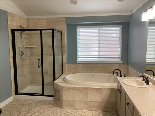 a bathroom with a granite countertop sink a mirror and a bathtub