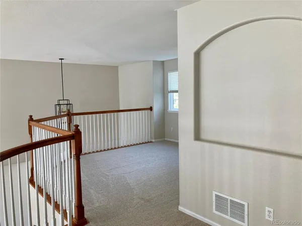 a view of a hallway with stairs