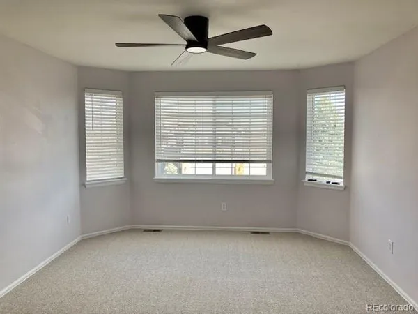 a view of room with a ceiling fan and window