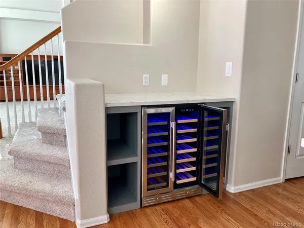 a view of a hallway with wooden floor and closet