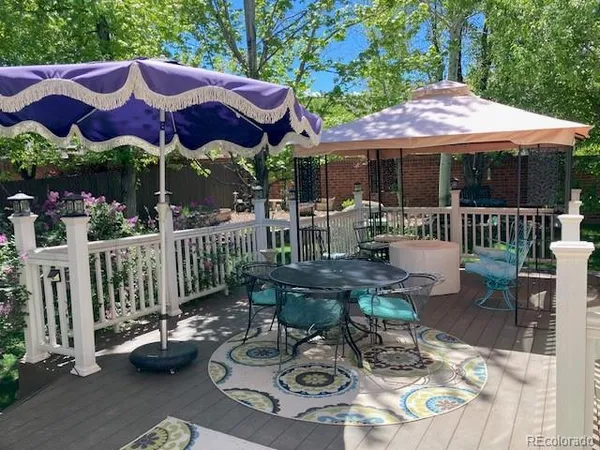 a view of a patio with furniture and umbrella