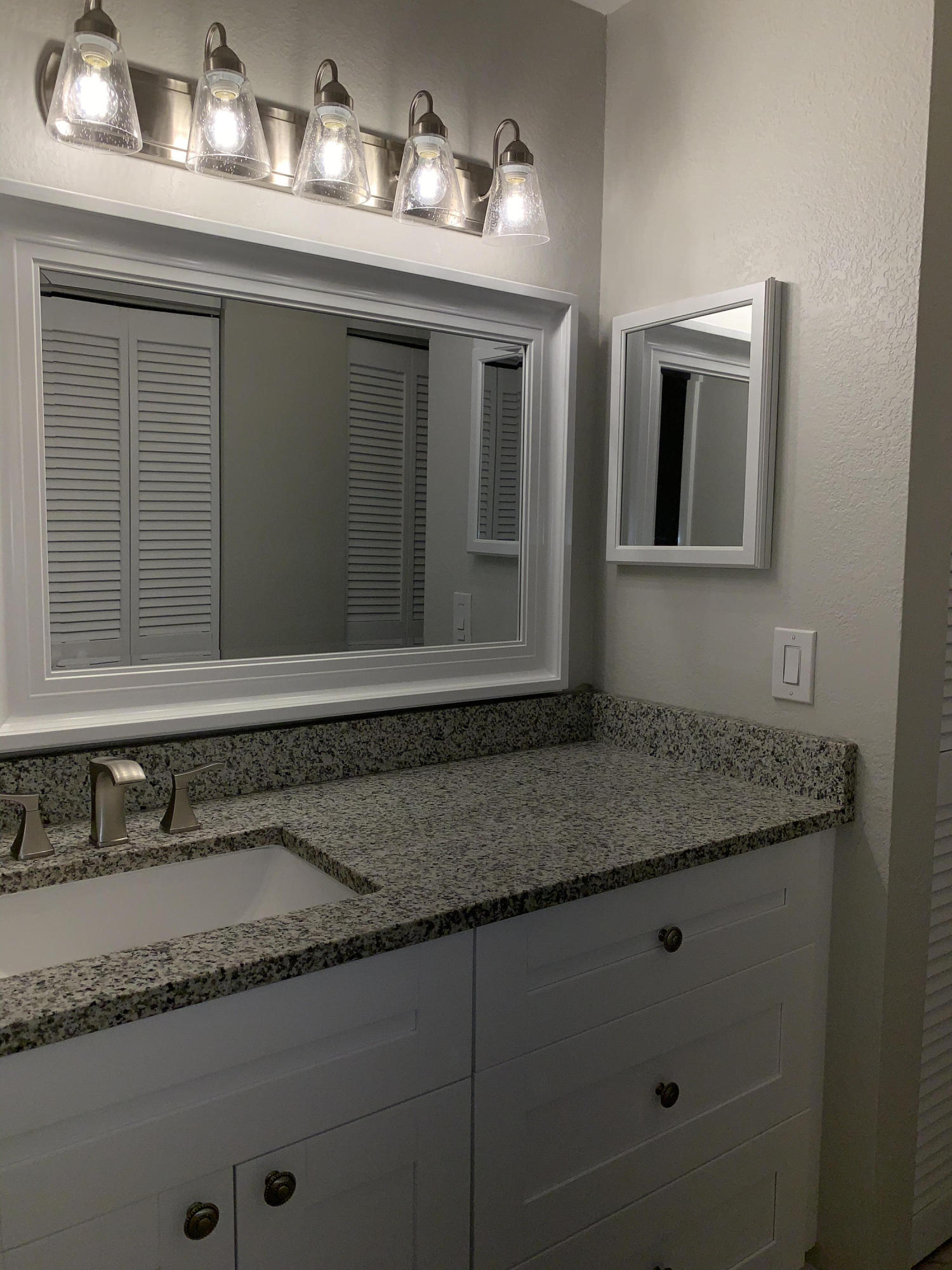 320 Southeast 2nd Avenue, Unit B1 Deerfield Beach, FL 33441 - Photo 12 of 22 a bathroom with a granite countertop sink and a mirror