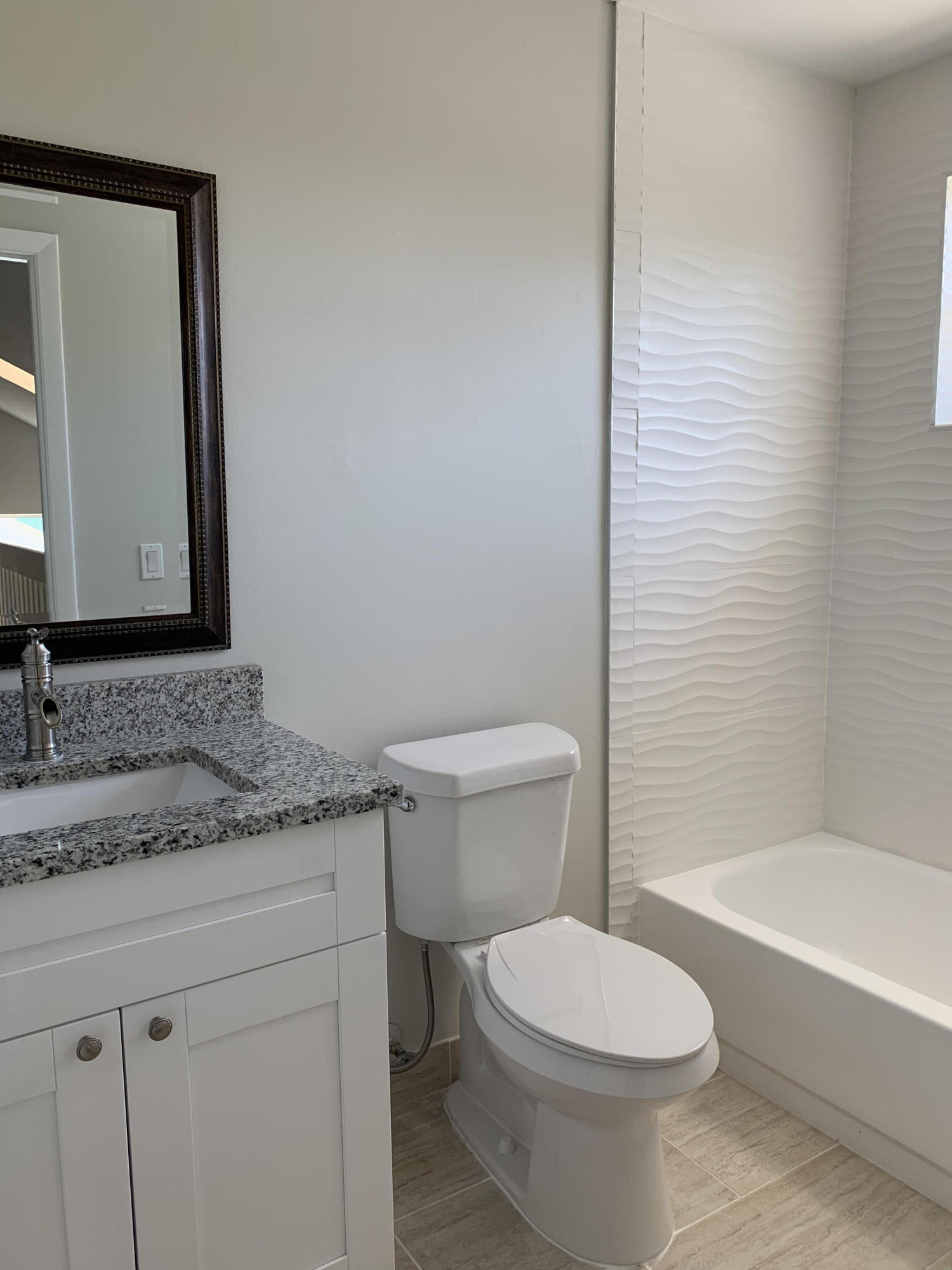 320 Southeast 2nd Avenue, Unit B1 Deerfield Beach, FL 33441 - Photo 14 of 22 a bathroom with a granite countertop toilet a sink and bathtub