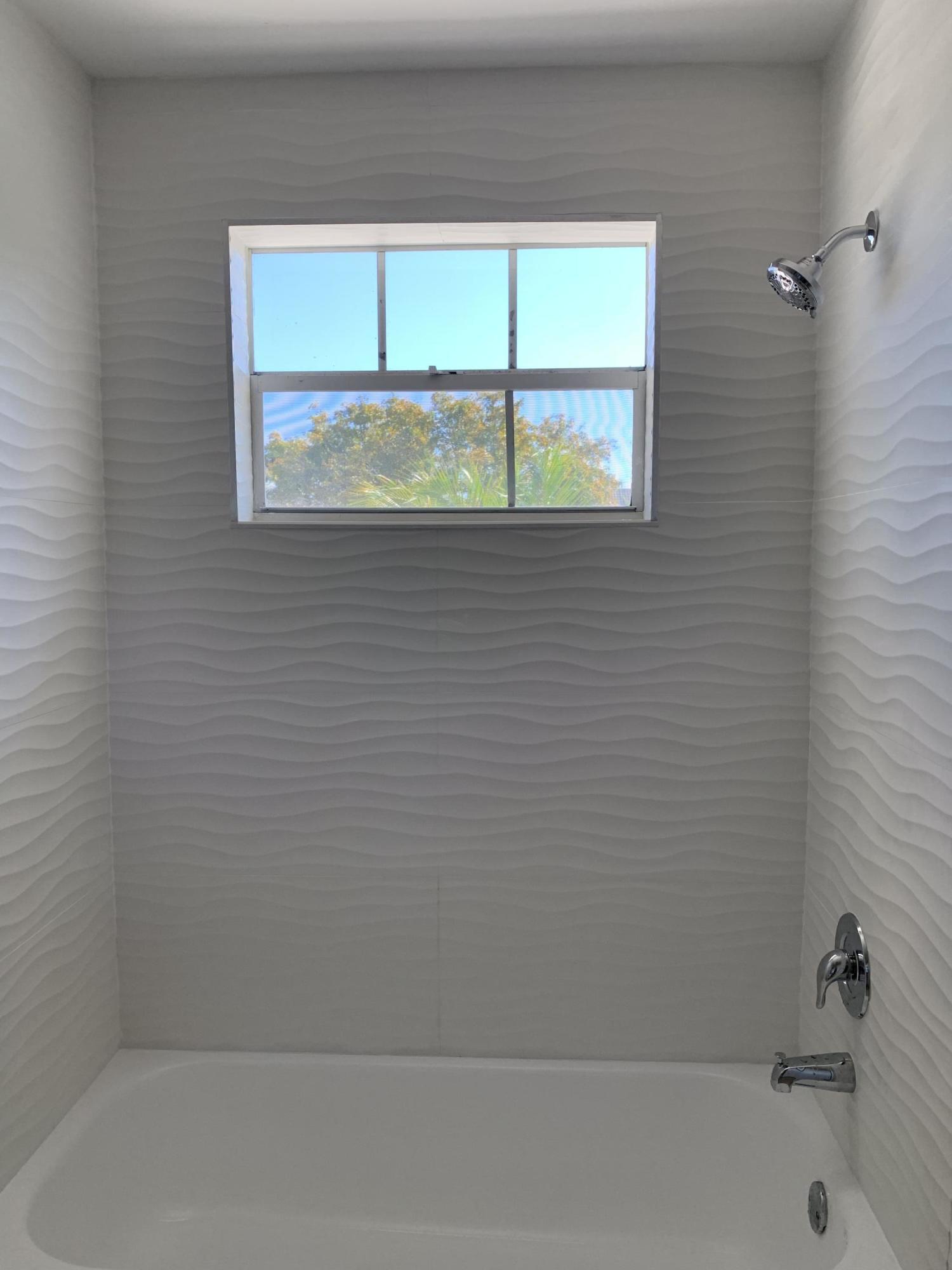 320 Southeast 2nd Avenue, Unit B1 Deerfield Beach, FL 33441 - Photo 15 of 22 a bathroom with a window